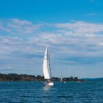 a sailboat in the middle of a body of water