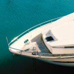 white and blue boat on body of water during daytime